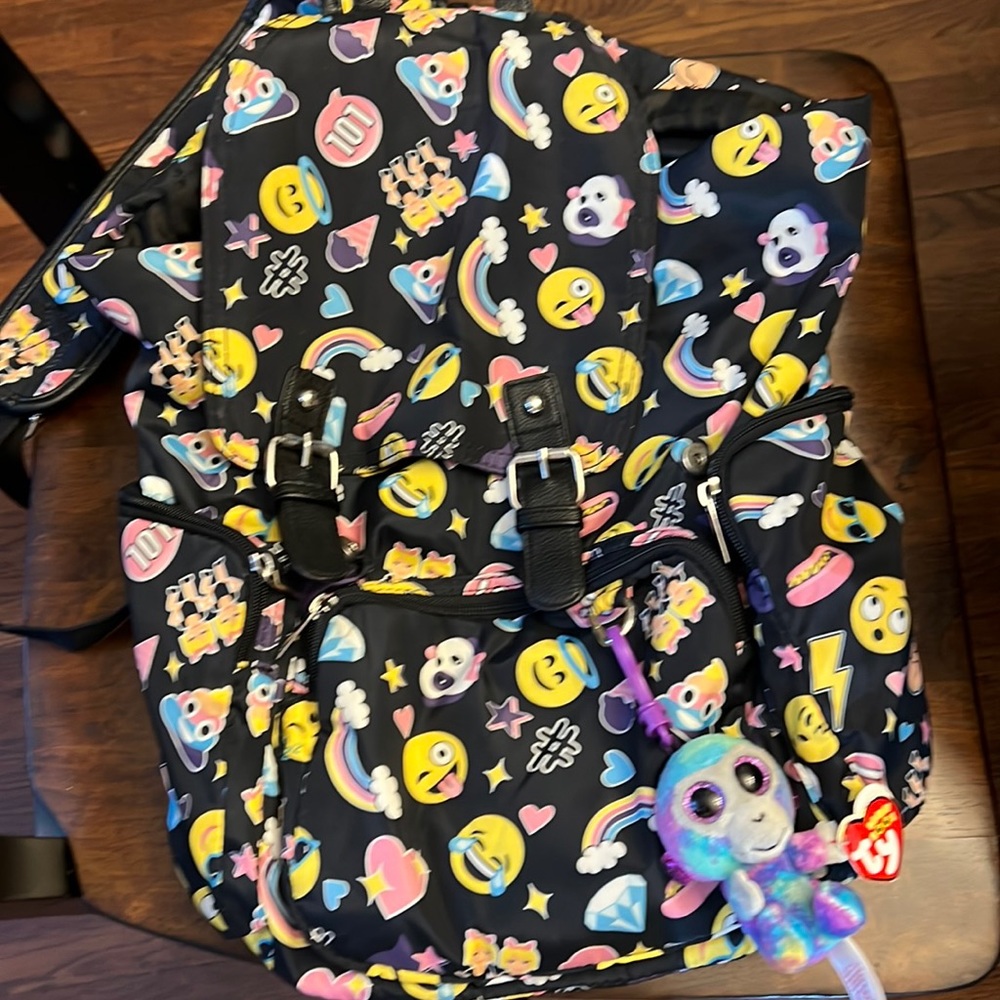 Emoji backpack with TY Bernie baby attached.